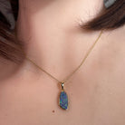 freeform Australian opal doublet pendant in yellow gold-plated silver, worn at the neck