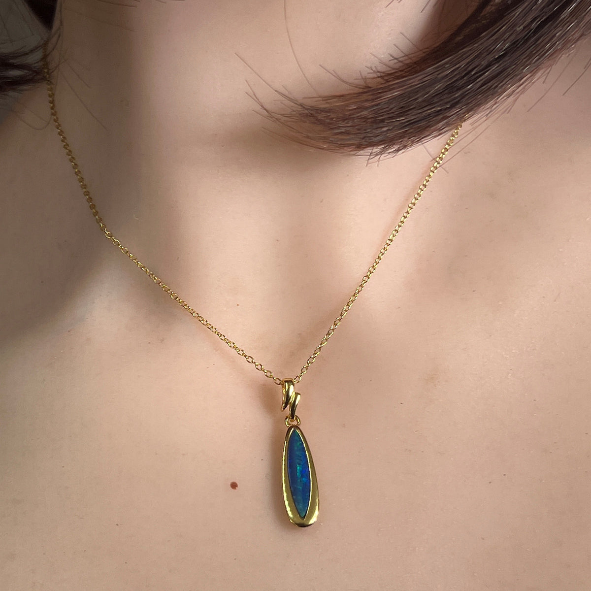Worn Australian opal doublet pendant in yellow gold-plated silver, blue and green, 17 x 5mm