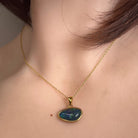 Australian opal triplet pendant worn at the neck, blue and green play-of-colour